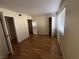 A vacant bedroom features multiple doorways, wood floors, and a bright window with blinds at 2686 Ruthe Duarte Ave, Las Vegas, NV 89121