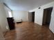 A large bedroom with wood floors, neutral walls, and two bright, window and multiple doorways at 2686 Ruthe Duarte Ave, Las Vegas, NV 89121