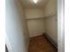 A narrow closet features wood floor and a mounted rail with shelf for storage at 2686 Ruthe Duarte Ave, Las Vegas, NV 89121