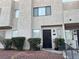 Two story stucco townhouse with dark brown door, landscaping, and walkway at 2686 Ruthe Duarte Ave, Las Vegas, NV 89121