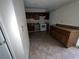 Efficient kitchen design with wood cabinets, white appliances, and tile flooring at 2686 Ruthe Duarte Ave, Las Vegas, NV 89121