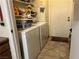 White washer and dryer in a well-lit laundry room with storage shelves at 2686 Ruthe Duarte Ave, Las Vegas, NV 89121