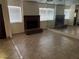 Open living room features a brick fireplace, neutral tile flooring, and mirrored wall at 2686 Ruthe Duarte Ave, Las Vegas, NV 89121