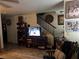Living room with staircase, tv, and wooden shelving unit at 2686 Ruthe Duarte Ave, Las Vegas, NV 89121