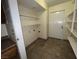This walk-in pantry has tiled floors, a white door, and several wall-mounted white shelves at 2686 Ruthe Duarte Ave, Las Vegas, NV 89121