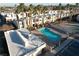 Aerial view of community pool and spa, surrounded by palm trees and residential buildings at 2686 Ruthe Duarte Ave, Las Vegas, NV 89121