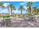 Outdoor grilling area with ample seating under palm trees at 322 Karen Ave # 1903, Las Vegas, NV 89109