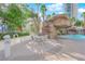 Relaxing pool area with a sandy seating area and a rock waterfall feature at 322 Karen Ave # 1903, Las Vegas, NV 89109