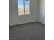 Bright bedroom with grey carpet and a large window at 353 Ukelele Pl # Lot 149, Henderson, NV 89015