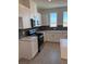 Modern kitchen with white cabinets, hexagonal backsplash and stainless steel appliances at 353 Ukelele Pl # Lot 149, Henderson, NV 89015