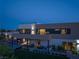 Modern home with expansive backyard and pool at dusk at 3530 Cosima Ln, Las Vegas, NV 89120