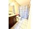 Bathroom features a dark wood vanity, decorative mirror, and a shower over tub at 3620 Park Oliver Dr, Las Vegas, NV 89110
