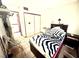 Comfortable bedroom featuring a closet and a full-sized bed with a black and white print comforter at 3620 Park Oliver Dr, Las Vegas, NV 89110