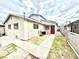 Two-story home featuring stucco siding, concrete walkway, a red door, and partial landscaping at 3620 Park Oliver Dr, Las Vegas, NV 89110