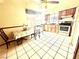 Eat-in kitchen featuring tile flooring, wood cabinets, and an island at 3620 Park Oliver Dr, Las Vegas, NV 89110