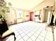 Spacious living room with tile floors, large windows, and a red front door at 3620 Park Oliver Dr, Las Vegas, NV 89110