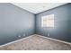 Simple bedroom with gray walls and carpet flooring at 3902 Winter Whitetail St, Las Vegas, NV 89122