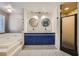 Bright bathroom with patterned floor, double sink vanity, soaking tub, and glass enclosed shower at 3954 Edgemoor Way, Las Vegas, NV 89121