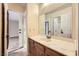 Bathroom with wood vanity and a large mirror at 3954 Edgemoor Way, Las Vegas, NV 89121