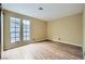 Empty bedroom features wood-look flooring, two large windows, and neutral walls at 3954 Edgemoor Way, Las Vegas, NV 89121