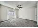 Neutral bedroom with a bay window, a ceiling fan and carpeted floor at 3954 Edgemoor Way, Las Vegas, NV 89121