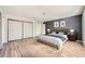 Bedroom features wood-look floors, paneled accent wall, and sliding door closet at 3954 Edgemoor Way, Las Vegas, NV 89121