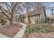 Charming Tudor-style home with a brick chimney and mature trees lining the walkway at 3954 Edgemoor Way, Las Vegas, NV 89121