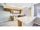 Kitchen with wood cabinets, white appliances, and a breakfast bar at 3954 Edgemoor Way, Las Vegas, NV 89121
