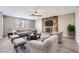 Bright living room featuring a stone fireplace, wood floors, and neutral-toned furniture at 3954 Edgemoor Way, Las Vegas, NV 89121