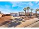 Single story home with landscaped yard, driveway, and palm trees at 421 Box Elder Way, Henderson, NV 89015