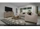 Open living room with modern furniture and access to a patio at 4714 Tindra Ave # Lot 15, Las Vegas, NV 89121