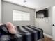 Well-lit bedroom, featuring a TV and window at 4924 Conglobate St, Las Vegas, NV 89122