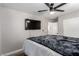 Bright bedroom with mounted TV and ceiling fan at 4924 Conglobate St, Las Vegas, NV 89122