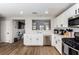 Modern kitchen with white cabinets, stainless steel appliances, and wood-look flooring at 4924 Conglobate St, Las Vegas, NV 89122
