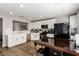 Modern kitchen with white cabinets, stainless steel appliances, and wood-look flooring at 4924 Conglobate St, Las Vegas, NV 89122
