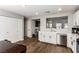 Modern kitchen with white cabinets, stainless steel appliances, and wood-look flooring at 4924 Conglobate St, Las Vegas, NV 89122