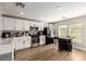 Modern kitchen with white cabinets, stainless steel appliances, and light wood flooring at 4924 Conglobate St, Las Vegas, NV 89122