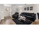 Living room with black leather furniture and hardwood floors at 4924 Conglobate St, Las Vegas, NV 89122