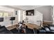 Living room with large TV, black furniture, and hardwood floors at 4924 Conglobate St, Las Vegas, NV 89122