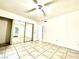 Bedroom with tile floors, mirrored closet doors, and ceiling fan at 5086 Jeffreys St # 201, Las Vegas, NV 89119