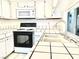 Galley kitchen with white cabinets and appliances at 5086 Jeffreys St # 201, Las Vegas, NV 89119