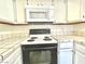 Kitchen features white cabinets, tile countertops, and a stove top at 5086 Jeffreys St # 201, Las Vegas, NV 89119