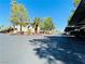 Community parking lot with covered parking and landscaping at 5086 Jeffreys St # 201, Las Vegas, NV 89119