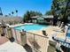 Community pool with fence, lounge chairs, and building at 5086 Jeffreys St # 201, Las Vegas, NV 89119