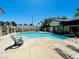 Community pool with lounge chairs and shaded seating area at 5086 Jeffreys St # 201, Las Vegas, NV 89119