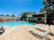 Community pool with lounge chairs and adjacent building at 5086 Jeffreys St # 201, Las Vegas, NV 89119