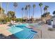 Community pool with lounge chairs and palm trees at 5261 Mission Carmel Ln # 202, Las Vegas, NV 89107