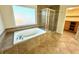 Relaxing bathroom featuring a garden tub and walk-in shower at 56 Toggle St, Henderson, NV 89012