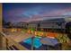 Twilight aerial view showcasing the neighborhood and backyard pool at 6276 Olde Lockford Ct, Las Vegas, NV 89139