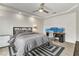 This contemporary bedroom features a ceiling fan, neutral gray tones, and a dedicated workstation at 6276 Olde Lockford Ct, Las Vegas, NV 89139